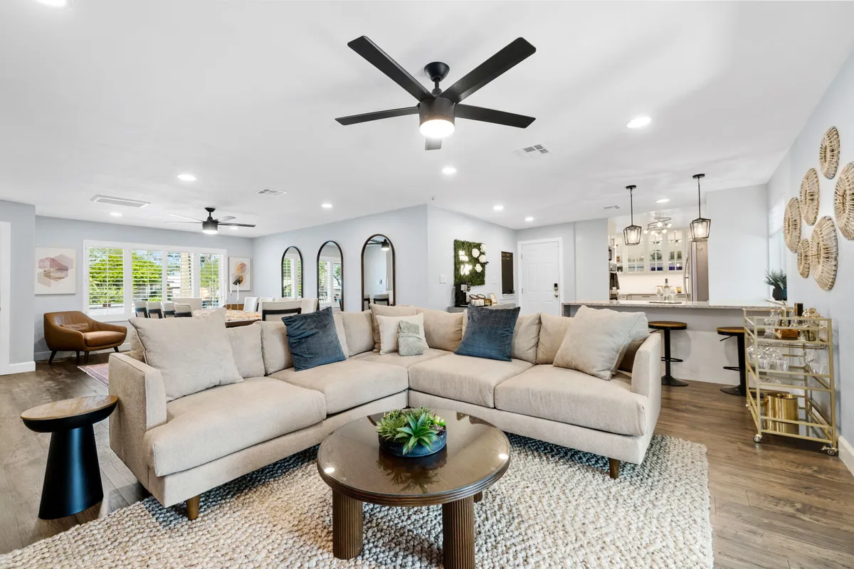 This image highlights a cozy sectional sofa, a coffee table, and tasteful decorative accents. The layout is ideal for socializing or relaxing, with an atmosphere that feels both comfortable and celebratory.