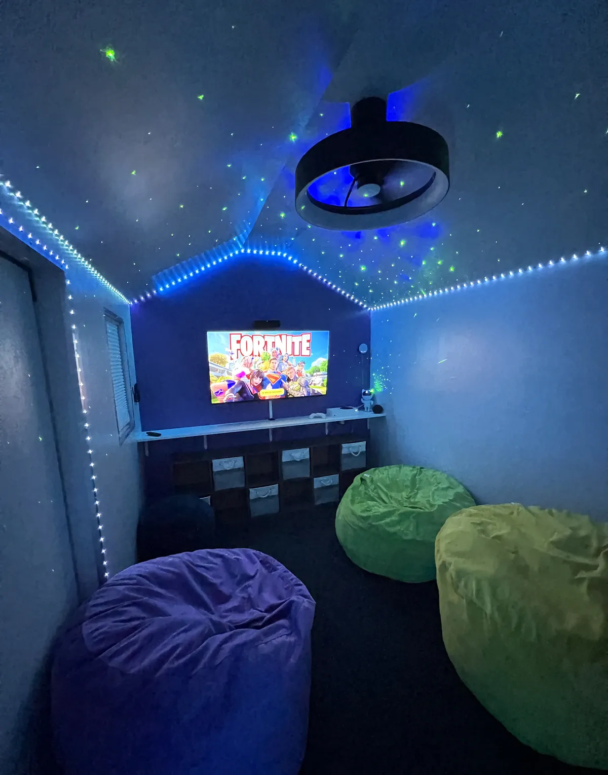 This interior photo captures a dedicated game room (KidZita) with vibrant LED lights, bean bags, and a large television—ideal for video gaming or movie nights. The fun, relaxed vibe is perfect for younger guests and family bonding indoors.